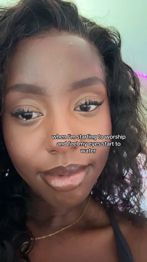 A close-up photo of a young Black woman's face. Her skin is smooth and dark, with a gentle smile. She has dark, curly hair and is wearing makeup. The background is a soft blend of colors. The text overlay is in a simple, white font.