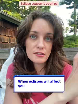 A woman with long brown hair and green eyes is centered in a medium shot. The background includes trees, foliage, and a light-colored building with a wooden exterior. The text overlay at the top says, "Eclipse season is upon us" in a beige colored text. At the bottom of the screen is a text box that reads, "When eclipses will affect you."