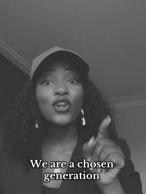 A black and white image of a woman with curly dark hair, wearing a baseball cap, blazer, and earrings, pointing her finger towards the camera and speaking. Text overlayed on the image reads "We are a chosen generation."