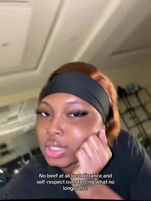 A close-up shot of a woman with brown hair and a black headband. Her hand is on her face as she gazes towards the camera with a slightly concerned expression. Text is overlaid at the bottom of the screen.