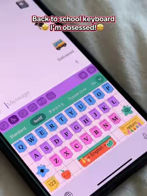 The cover image displays a close-up of a smartphone screen showcasing a custom keyboard design. The keyboard features a pastel color scheme with a grid pattern, and each key has a different color. The phone displays a message interface with a 'Delivered' notification and a text input field. The overall composition is bright and colorful, emphasizing the aesthetic customization of the keyboard.