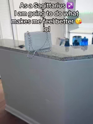 A light-filled kitchen scene with a white countertop and a handbag resting on it. Text overlays inform the viewer.