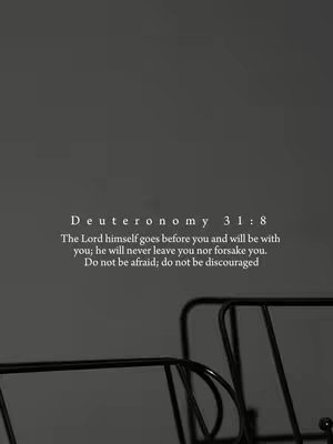 A simple image with a dark gray background, featuring a white text overlay displaying a Bible verse with a black decorative element at the bottom. The text is centered and includes the book, chapter, and verse (Deuteronomy 31:8) along with the passage itself. Below the text are two black metal decorative elements, which appear to be parts of a bed or a similar structure. The overall composition is minimalist and serene, with a focus on the message.