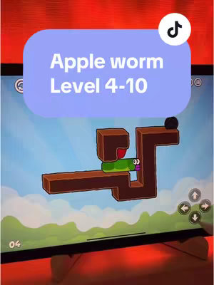 The cover image shows a mobile gaming interface on a tablet. The game seems to be a puzzle game with a green worm-like character navigating a path that is shaped like a maze. The top portion of the screen displays the game level, and on the bottom of the screen are controls. The background includes a sky with blue gradients and a green lower landscape. A text overlay in a purple bubble displays the game's name and level range. The overall design is clean and the color palette is bright.