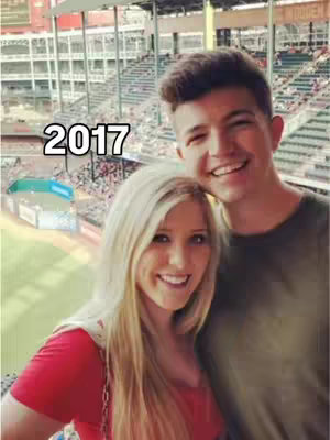 A selfie of a man and a woman smiling in front of a baseball stadium. The man is on the right and has short, dark hair. The woman is on the left, having long blonde hair and wearing a red top. The number "2017" is overlaid on the image in a white, bold font.