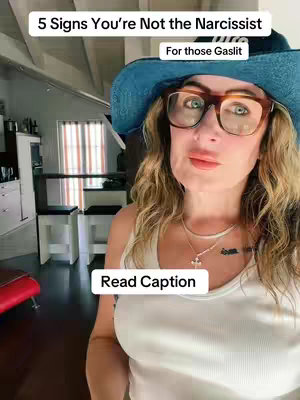 The image is a selfie-style video with the primary focus on the creator. She is looking slightly towards the camera. The background features interior design elements like cabinetry and a window with light filtering through.