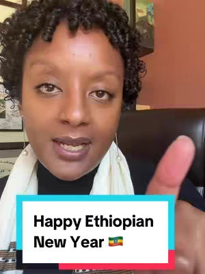 A dark-skinned woman with curly hair smiles brightly. A colorful banner below reads "Happy Ethiopian New Year" with the Ethiopian flag graphic. She is in front of a dark background, possibly a room with some decoration.