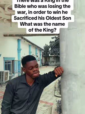 A man is leaning against a concrete column. The top-left of the image has text overlaid, which is a bible-themed quiz. The man looks like he is thinking, and he is wearing a long sleeve black shirt.