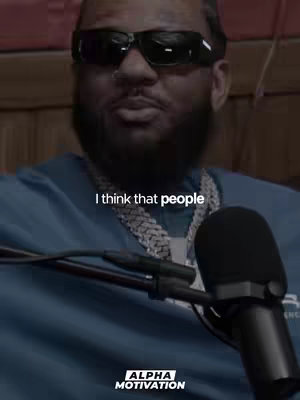 The cover image features a close-up shot of a man wearing sunglasses and a blue shirt, with the text overlayed. The man is speaking into a microphone. The background suggests a podcast or interview setting, with the 'ALPHA MOTIVATION' logo present.