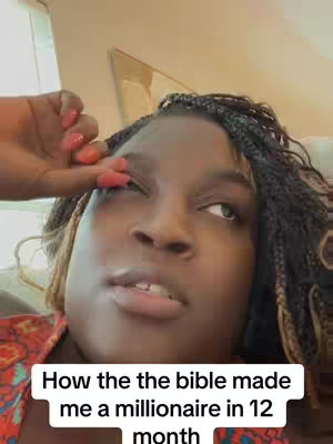 A close-up shot focusing on a Black woman with braided hair. She is looking up with an expression of thought or reflection. A hand with long, painted nails is reaching towards her. Below, text appears on the cover.
