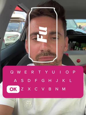 A selfie taken from inside a car, the background includes other cars and a building. The foreground features a man's face with a digital overlay in the form of a can. Below the man’s chin is a pink rectangle acting as an on-screen keyboard.