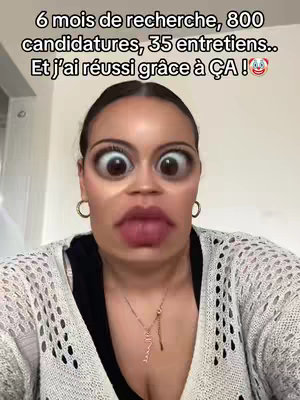 A selfie-style image featuring a young woman with an exaggerated facial expression due to a humorous filter that enlarges her eyes and distorts her mouth. The text overlay states that after 6 months, 800 applications, and 35 interviews, she succeeded 'thanks to this', likely referring to her exaggerated face. She's wearing a white knit cardigan over a dark top and a gold necklace.