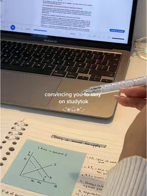 The cover image shows a person's desk with a Macbook, a notebook, a pen, and a sticky note with a graph for 'Theory of demand and supply'. The text overlay says 'convincing you to stay on studytok'. The color palette is mostly neutral with white, beige, and blue.
