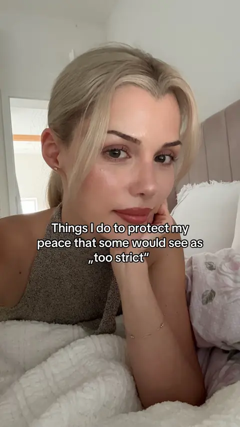 A blonde woman, lying on a bed, looks directly at the camera with a neutral expression. The text overlay includes 'Things I do to protect my peace that some would see as too strict'. She is wearing a neutral-toned top, and the background is softly blurred.