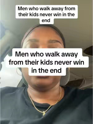 A selfie-style video cover image featuring a woman from the chest up, filmed indoors. She has dark skin and appears to be inside a car. Two white text boxes with black text are overlaid on the top of the image. She has a gold necklace and seems to be looking at the camera at eye level.