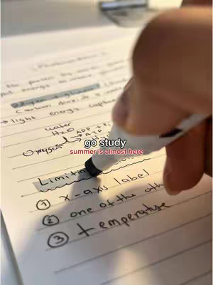 A hand holding a pen is writing on a notebook with various diagrams and notes, with the hook text overlayed at the top