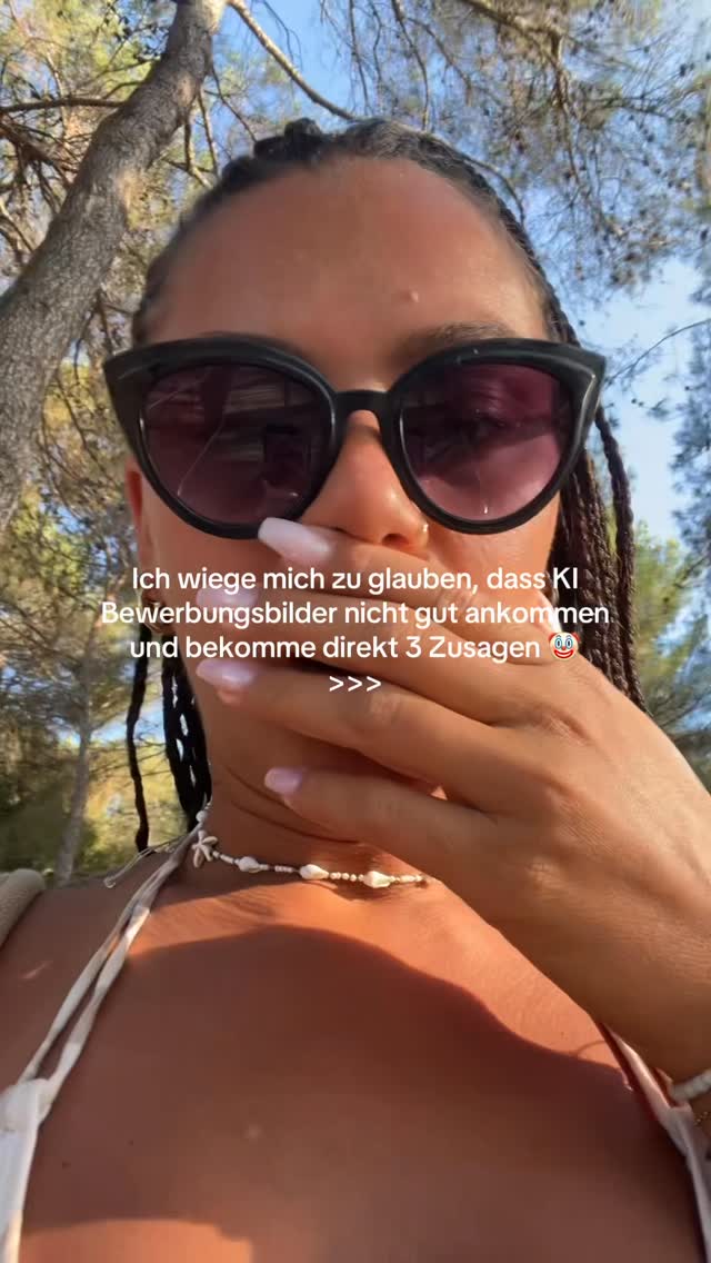 A woman is shown from the chest up, wearing sunglasses. She has long black braids and is in a sunny environment with trees and blue sky visible in the background. The text overlay is white and placed over the image.