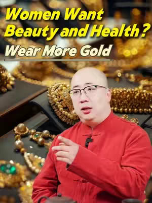 The cover image features a man wearing glasses and a red shirt, seated in front of a display of golden jewelry. The background is filled with various pieces of gold jewelry. Text in a yellow font overlay reads: "Women Want Beauty and Health? Wear More Gold". The overall composition is well-lit with a focus on the jewelry.