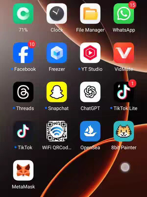 A screenshot of a mobile phone home screen displays multiple app icons arranged in a grid format. The background of the screen has a blurred, orange-brown gradient effect. The apps include: Facebook, Threads, TikTok, and others like WhatsApp, File Manager, and ChatGPT. Some apps have notification badges. The top-left corner shows a battery indicator. Overall, the image is clean and organized.