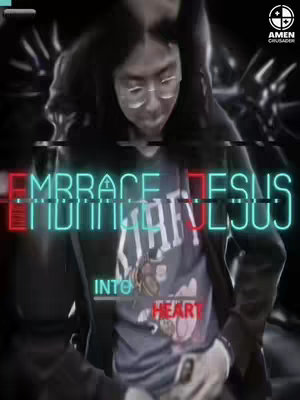 The image shows a person, likely the creator, wearing glasses, with a superimposed overlay of text in bright colors. The text 'EMBRACE JESUS' is prominent, positioned across the upper part of the person's upper body.