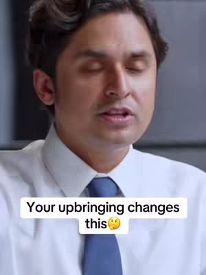 A close-up shot of a man wearing a white shirt and blue tie, with his eyes closed. Text overlayed at the bottom says: "Your upbringing changes this" with a thinking face emoji.