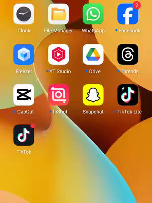 The cover image shows a phone screen with several app icons arranged on a yellow and orange gradient background. Prominent app icons include Clock, File Manager, WhatsApp, Facebook, Freezer, YT Studio, Drive, Threads, CapCut, InShot, Snapchat, TikTok Lite, and TikTok. The overall composition is clean and organized, with attention-grabbing colorful app icons.
