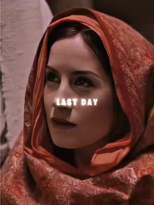 The cover image features a woman with dark eyes and brown hair, wearing a red headscarf. The image is softly lit and has a slightly blurred background. The text 'LAST DAY' in a white glowing font is overlaid on the image, positioned across the woman's nose.