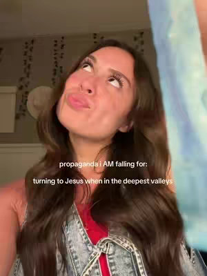 A woman with long brown hair looks upwards with a contemplative expression, her mouth slightly pursed. A denim jacket is partially visible over a red top, with a background that implies a domestic setting. Text overlays describe her feelings.