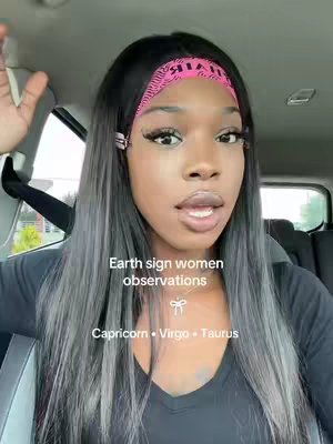 A selfie-style shot of a woman in a car, looking toward the camera with a slightly open mouth. She's wearing a pink headband with text, and her hair is long and highlighted with gray tones. Text overlays state 'Earth sign women observations' and list Capricorn, Virgo, and Taurus.