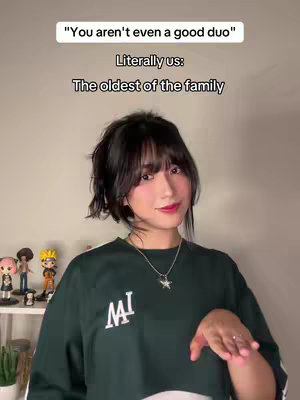 A young woman looks at the camera with a slight smile, the text is overlaid in a simple clean font. The background is beige. In the background are figurines on a shelf.