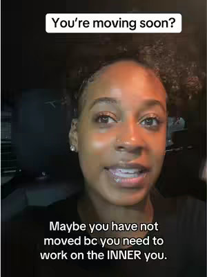 A woman with dark skin is centered in front of a dark background, likely inside a vehicle. She has curly hair pulled back and is looking at the camera while talking. Text overlays appear at the top and the bottom of the frame. She is wearing dark clothing and has a gentle expression with slight smile.