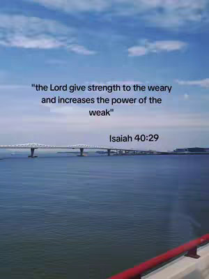The image depicts a serene landscape with a bridge spanning a body of water under a bright blue sky with some clouds. Overlaid on this setting is text, likely a quote from the Bible, with the verse reference, adding a motivational or spiritual message to the scenic view.