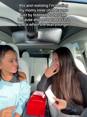 The image shows a woman sitting in the front seat of a car, facing another woman. The background includes the car's interior, such as seats and a rearview mirror. The text overlay mentions healing and a mother-daughter relationship, positioning it as a driving scene.