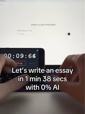 A person's hands are shown typing on a laptop keyboard, with a smartphone in the foreground displaying a timer.