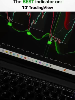 A laptop screen displaying a TradingView chart analysis with what appears to be technical indicators. The screen is angled, showing the keyboard in the foreground and chart data in the background. The chart's background is black, with rising and falling bars in green and red and a series of connected lines. Overlay text labels such as "Buy" are indicated. The image is illuminated by the screen's glow, creating a sense of depth and a slight vignette effect.