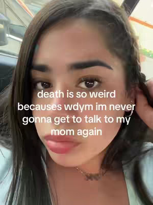 A selfie-style video cover. A young woman with dark hair and fair skin is in the center, her face filling most of the frame. She is positioned in what appears to be a car, as suggested by the glimpse of a car's interior visible behind her. The background is softly out of focus, emphasizing the woman's face. On overlayed text, in a handwritten style font, is in the image.