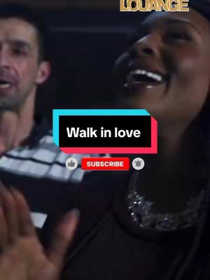 The cover image features a woman and a man with overlaid text. The woman, central to the frame and on right, is smiling broadly with her head tilted slightly upward. The man on the left side of the frame is also smiling. Overlaid on the image is a rectangular text box with white text on a black background reading Walk in love. Below this is a like button and subscribe button.
