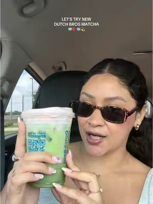 A woman in sunglasses holds a matcha drink in a clear cup; text above the woman spells out the name of the drink.