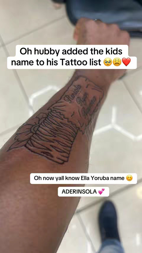 A close-up shot of a person's arm, focusing on a detailed tattoo of a flower design and names, with text overlayed in a white box over the arm.