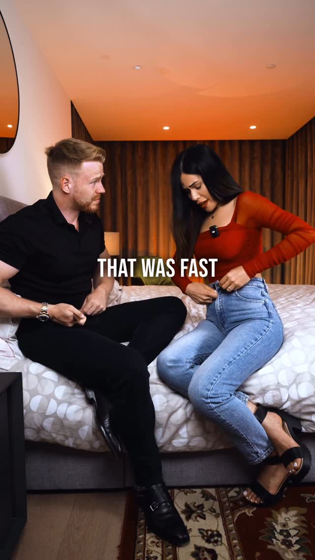 A cover image of a man and a woman in a bedroom. The man is wearing a black shirt and is looking at the woman. The woman is wearing a red top and jeans, is adjusting her jeans, and has a concerned expression. The text overlay says "THAT WAS FAST".