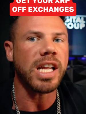 A close-up shot of a man with a beard, wearing a chain necklace, looking directly at the camera with a serious expression. A red banner with white text that reads 'GET YOUR XRP OFF EXCHANGES' is above him.