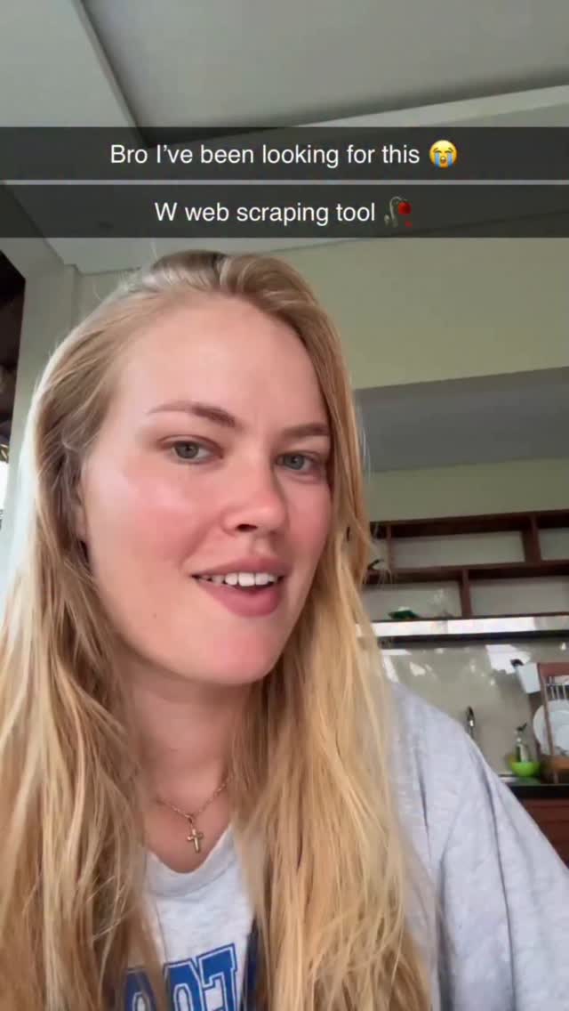 A young woman with long blonde hair is smiling and talking to the camera. She is in a room with what appears to be a window, and there is text overlayed on the video.