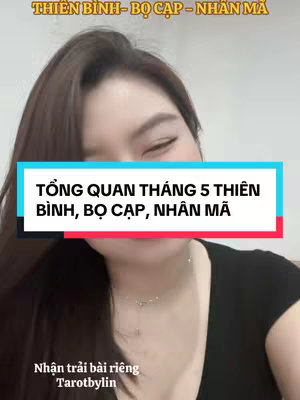 A woman with long, dark hair is centered in the frame, with a teal and black rectangle overlaid at the bottom of her face. The rectangle contains white text. Behind her, a light grey wall provides a neutral backdrop.