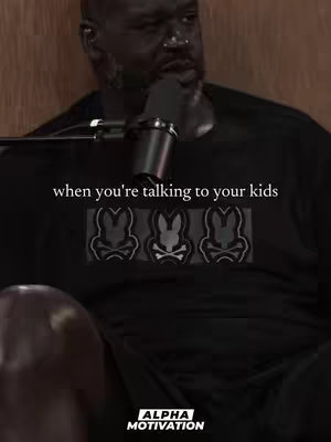 The cover image shows a close-up of a Black man, with a serious expression, holding a microphone. Text overlayed on the dark shirt he's wearing reads, 'when you're talking to your kids,'. The backdrop appears to be a wooden surface. The 'Alpha Motivation' logo is visible at the bottom. The image's composition is vertical, suitable for a social media post