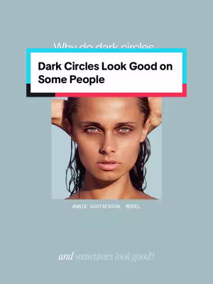 The image is a vertical composition with a light blue background. A woman's face is centered, looking directly at the viewer. Her hair is wet, and styled back behind her ears. She has dark eye makeup, highlighting dark circles. The title "Dark Circles Look Good on Some People" is displayed in a rectangular box with white text on a light blue background and a red highlight. Below the woman's face is her name "ANNIE GUSTAFSSON, MODEL". At the bottom, the text "and sometimes look good?" is present in a light gray color.