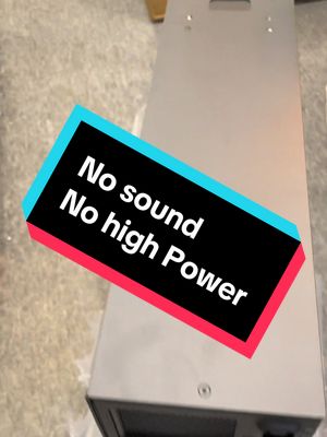 A rectangular silver metal machine with a text overlay. The text overlay uses a black background with a cyan and pink border, containing the words, 'No sound. No high Power'.