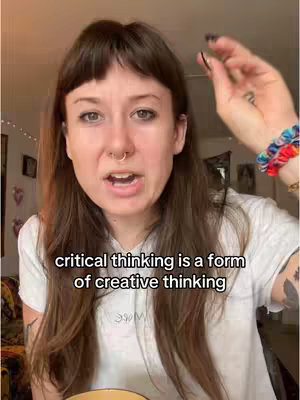 A woman with brown hair and a nose ring looks directly at the camera, speaking with an open mouth. Text overlayed onto the video reads critical thinking is a form of creative thinking