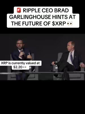 The cover image shows a panel discussion featuring two men in suits seated on chairs. Above them is a white banner containing text, and below them, beneath a black space, is more text.