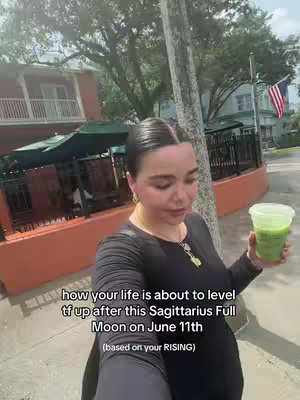A woman holding a green drink stands in front of an orange building on a sunny day. Text overlays the image, referencing astrology.