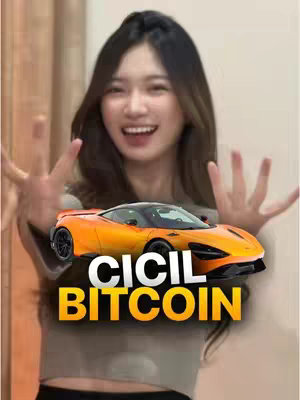 A woman with long dark hair is smiling, holding up her hands making peace signs. In front of her is a bright orange sports car with the words "CICIL BITCOIN" in white text. The background appears to be a room.
